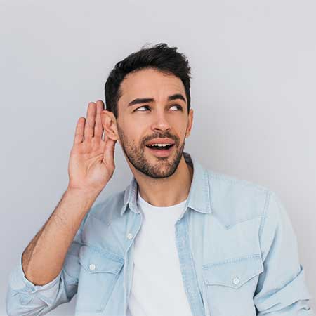 Man cupping his ear to hear better.