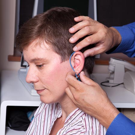 Hearing instrument specialist performing a real ear measurement.